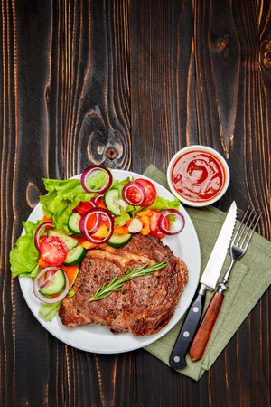 Roasted organic shin of beef meat on wooden backgroundの写真素材