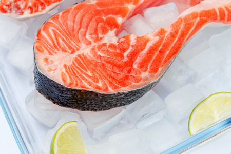 Fresh Raw Salmon Red Fish Steak isolated on iceの写真素材