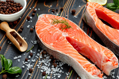 Fresh Raw Salmon Red Fish Steak on wooden backgroundの写真素材