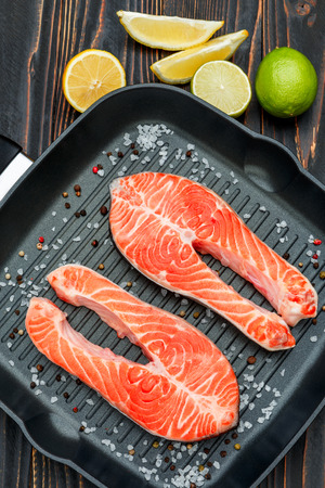 Fresh Raw Salmon Red Fish Steak on wooden backgroundの写真素材