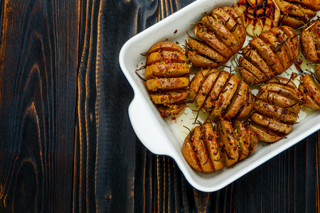 Baked spicy potatoes in baking dish closeupの写真素材