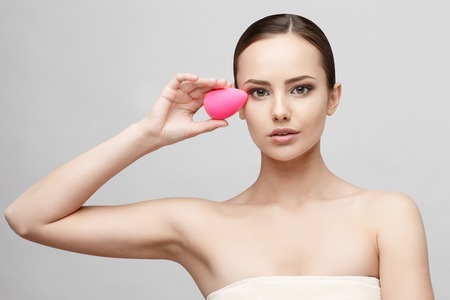 Beautiful Face of Young Woman with Clean Fresh Skin close up isolated on white. Beauty Portrait. Beautiful Spa Woman Smiling. Perfect Fresh Skin. Pure Beauty Model. Youth and Skin Care Conceptの写真素材