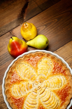 Beautiful fresh organic pear tart on wooden backgroundの写真素材