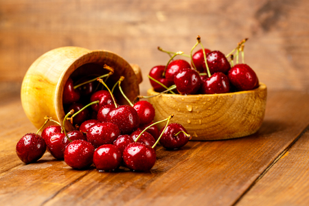 Studio shot of fresh natural cherries on wooden backgroundの写真素材