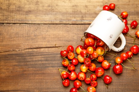 Studio shot of fresh natural cherries on wooden backgroundの写真素材