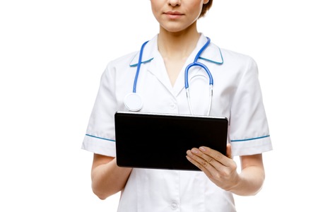 Young woman doctor isolated on white background holding tablet pcの写真素材