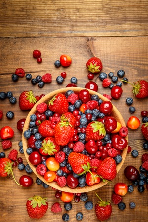 Studio shot of summer berries on wooden backgroundの写真素材