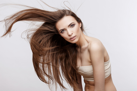 Beautiful Face of Young Woman with Clean Fresh Skin close up isolated on white. Beauty Portrait. Beautiful Spa Woman Smiling. Perfect Fresh Skin. Pure Beauty Model. Youth and Skin Care Conceptの写真素材