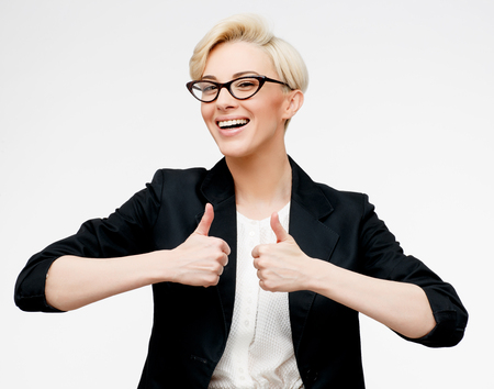 Young beautiful caucasian business woman wearing jacket studio portraitの写真素材