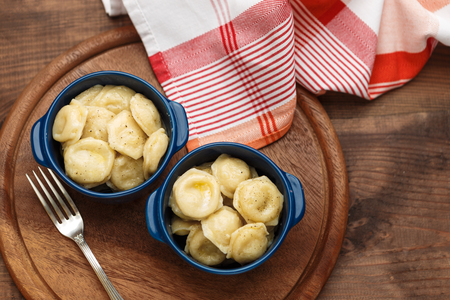 Meat Dumplings - russian boiled pelmeni in plate on wooden tableの写真素材