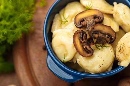Meat Dumplings - russian boiled pelmeni in plate on wooden tableの写真素材