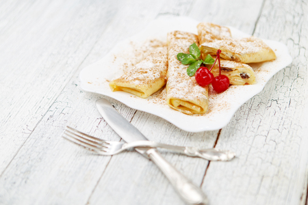 Tasty crepes on wooden table studio shotの写真素材