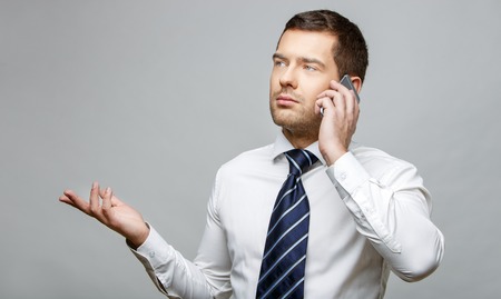 Handsome stylish businessman on grey backgroundの写真素材