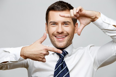 Handsome stylish businessman on grey backgroundの写真素材