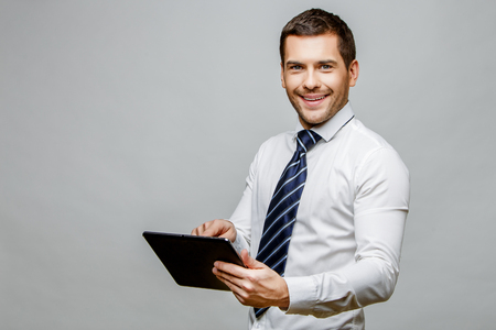 Handsome stylish businessman on grey backgroundの写真素材