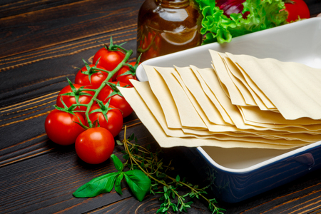 dried uncooked lasagna pasta sheets and ingridientsの写真素材