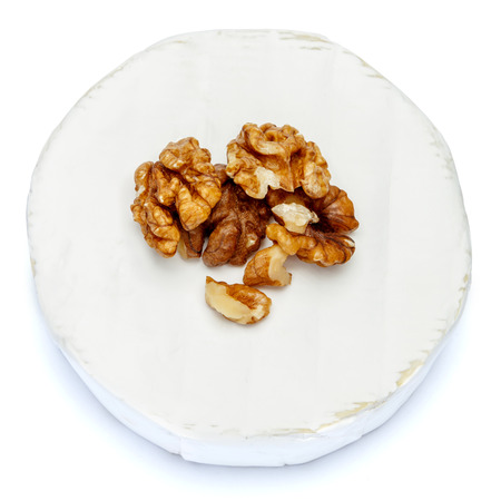 Round brie or camambert cheese on a white backgroundの写真素材