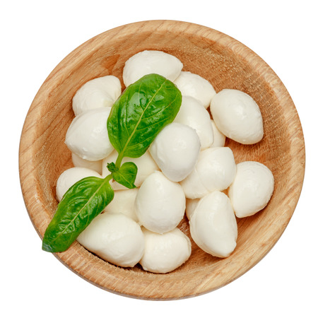 Mozzarella cheese and basil in bowl on white backgroundの写真素材