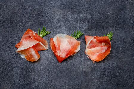 Italian prosciutto crudo or spanish jamon. Raw ham on white background.の写真素材