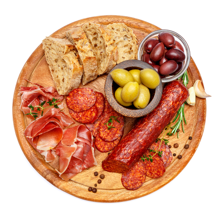 Dried organic salami sausage or spanish chorizo on wooden cutting boardの写真素材