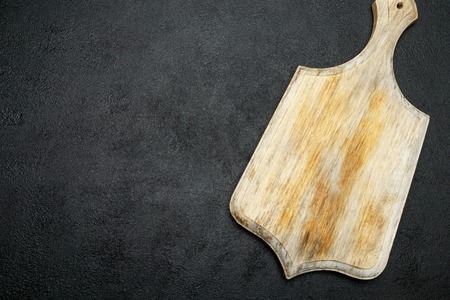 decorative wooden serving or cutting board on concrete background