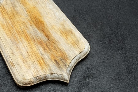 decorative wooden serving or cutting board on concrete backgroundの写真素材