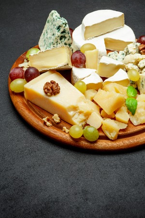 Cheese plate with Assorted cheeses Camembert, Brie, Parmesan blue cheese, goatの写真素材