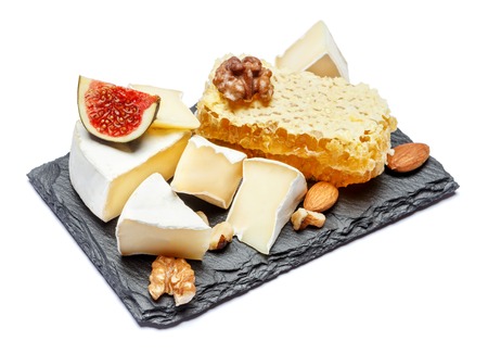 Camembert cheese with honey, figs, walnuts on stone boardの写真素材