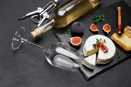Camembert cheese and cut a slice on stone serving boardの写真素材