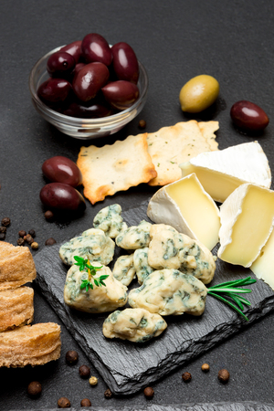 Slice of French Roquefort cheese on stone boardの写真素材