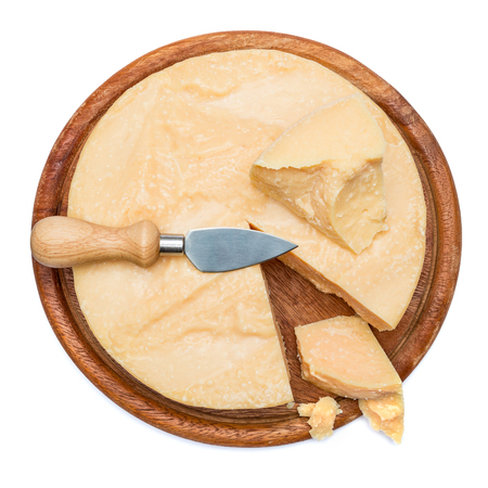 Whole round Head and pieces of parmesan or parmigianoの写真素材