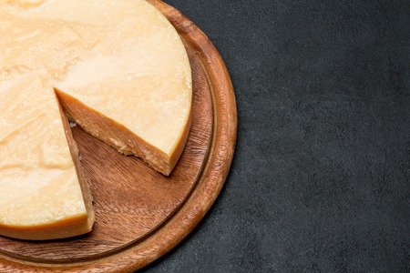 Whole round Head and pieces of parmesan or parmigiano