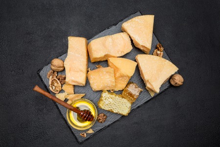 pieces of parmesan or parmigiano cheese and honeyの写真素材