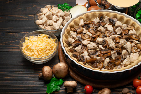 shortbread dough for baking quiche tart and filling in baking formの写真素材