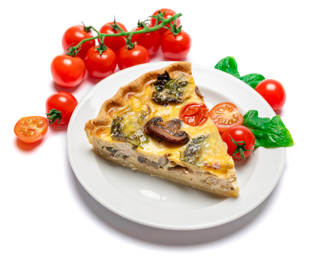 Slice of traditonal homemade spinach chicken quiche tart or pie on plate