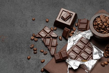 dark organic chocolate and coffee beans on concrete backgroundの写真素材