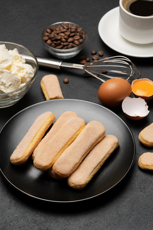 Ingredients for cooking tiramisu - Savoiardi biscuit cookies, mascarpone, cream, sugar, cocoa, coffee and eggの写真素材