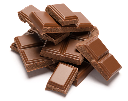 Milk organic chocolate pieces isolated on white backgroundの写真素材