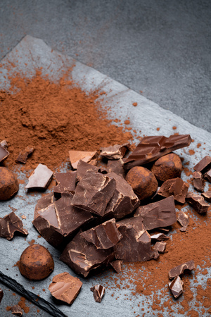 Dark or milk organic chocolate pieces on dark concrete backgoundの写真素材