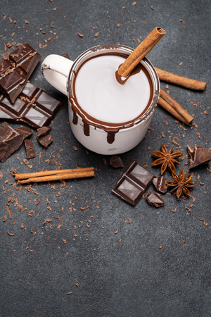 Cup of hot chocolate and pieces of chocolat on dark concrete backgroundの写真素材