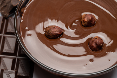 glass bowl of chocolate cream or melted chocolate isolated on whiteの写真素材