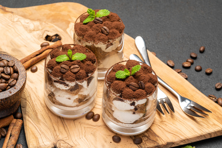 Classic tiramisu dessert in a glass on dark concrete backgroundの写真素材