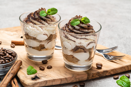 Classic tiramisu dessert in a glass on dark concrete backgroundの写真素材