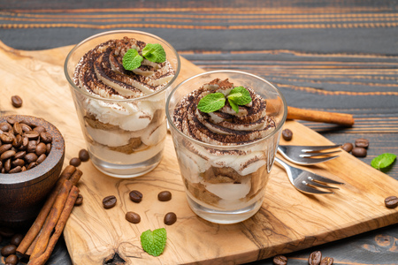 Classic tiramisu dessert in a glass on wooden backgroundの写真素材