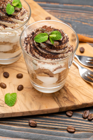 Classic tiramisu dessert in a glass on wooden backgroundの写真素材