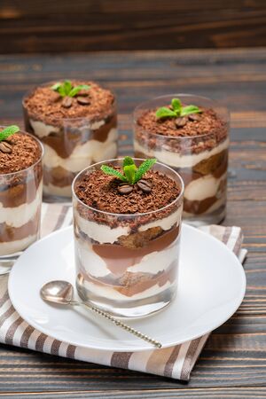 Classic tiramisu dessert in a glass on wooden backgroundの写真素材