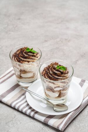Classic tiramisu dessert in a glass on concrete backgroundの写真素材