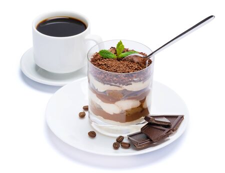 Classic tiramisu dessert in a glass, cup of coffee and pieces of chocolate on white background with clipping pathの写真素材