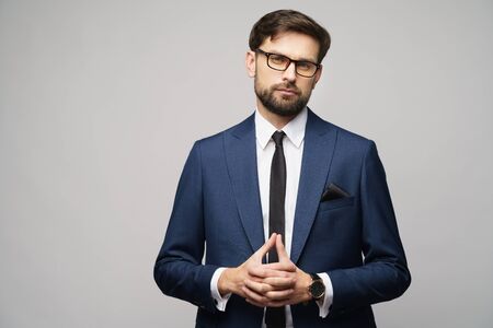 studio photo of young handsome businessman wearing suit