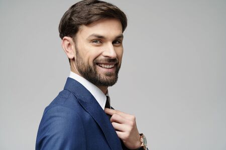 Studuo shot of thinking businessman wearing suitの写真素材